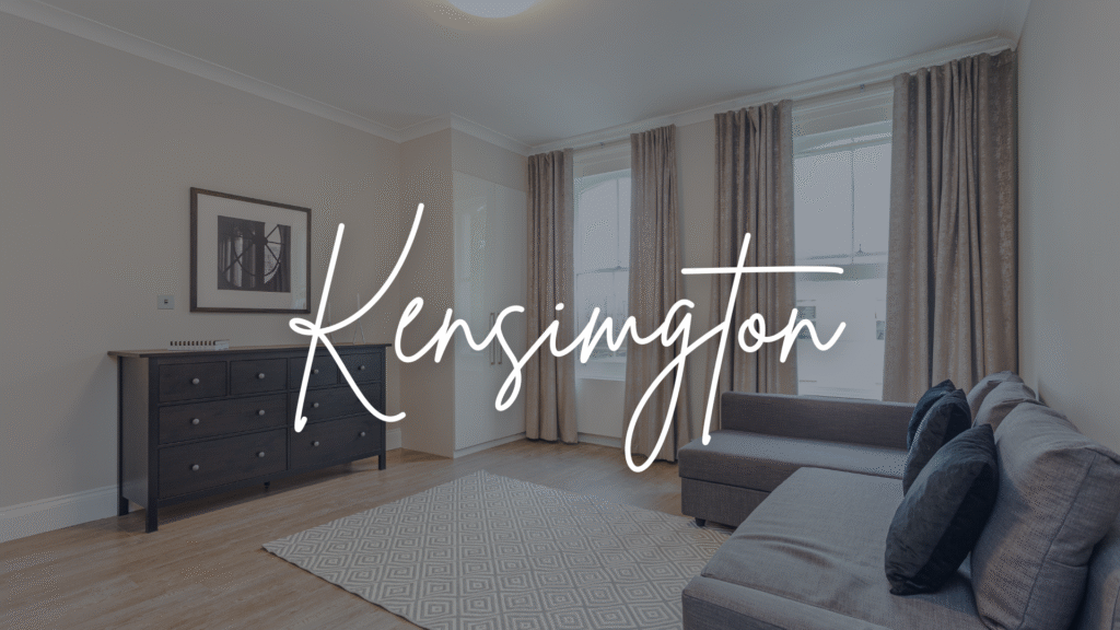Kensington serviced apartment living room with large windows, sofa and dresser in a calm, light space.
